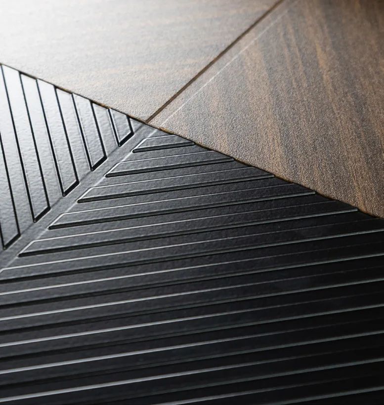 Close-up of Veyna Deluxe milled black surface and walnut decor